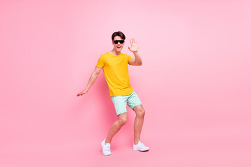 Fototapeta na wymiar Photo of carefree disco cheerful guy dance beach party wear yellow t-shirt shorts isolated on pink background