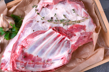 Raw mutton ribs with thyme on parchment paper. Meat product