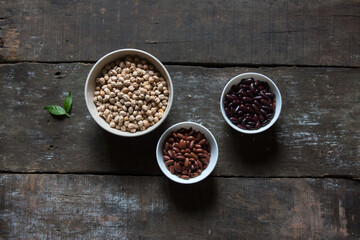 Protein food ingredients chick peas and kidney beans in bowl on wooden background.