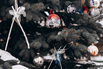 Christmas tree decorated with toys and garlands close-up, holidays location, selective focus, noise and grain in the photo