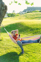 portrait of attractive nerd   man with glasses in the park with green lawn have a nice sunset in ...