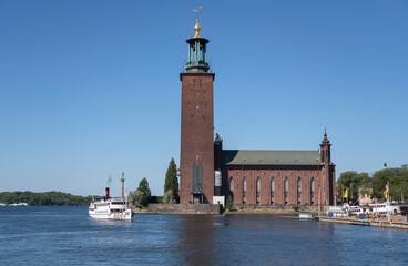 Old steam ship Prins Carl Philip leaving the pier at the Stockholm Town City Hall