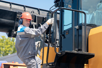 Driver of bulldozer, industry man builder on construction site. Concept mining machinery