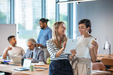 Shot of two businesswomen discussing something on a digital tablet. Business colleagues having a...