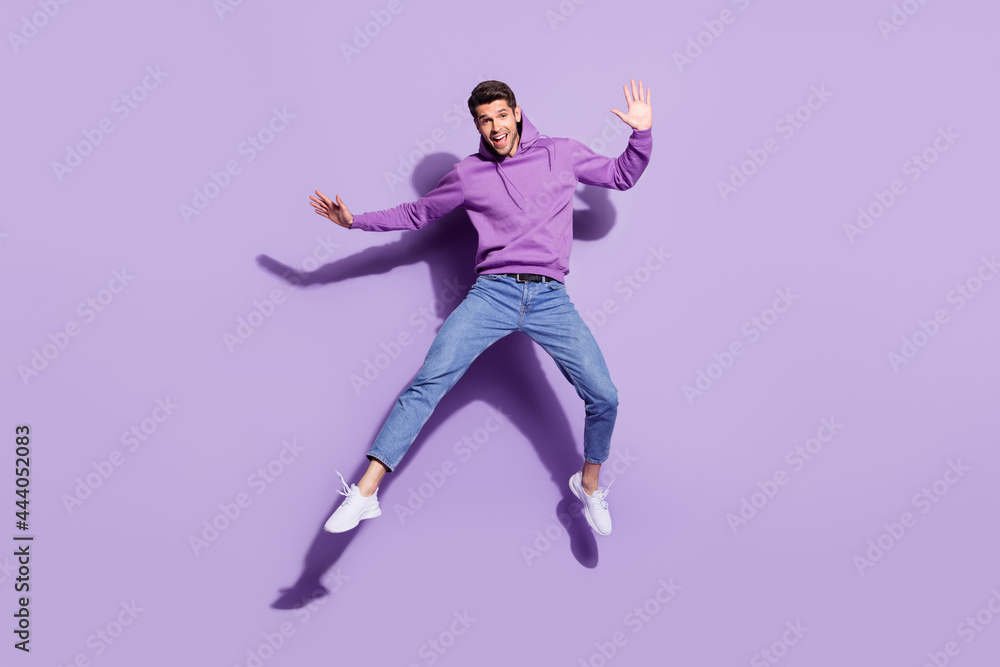 Poster full length body size view of attractive funny cheerful guy jumping good mood rest isolated over pur