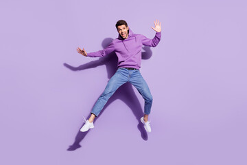 Fototapeta na wymiar Full length body size view of attractive funny cheerful guy jumping good mood rest isolated over purple violet color background