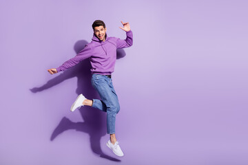 Fototapeta na wymiar Full length body size view of attractive funny cheerful guy jumping having fun isolated over purple violet color background