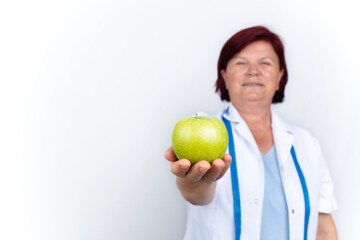 mature female doctor, healthy eating concept, isolated on white background.
