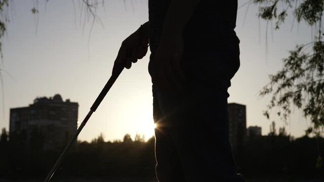 Hand of a blind man with a cane