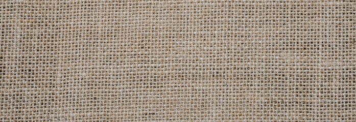 Naklejka na ściany i meble Rough hessian background with flecks of varying colors of beige and brown. with copy space. office desk concept, Hessian sackcloth burlap woven texture background.