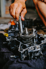 Assemble the motorcycle engine gear by a maintenance technician and check it.	