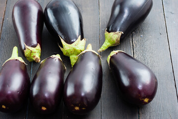 eggplants on black wood table background