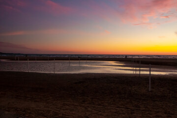 Fototapeta na wymiar Orange sky at sunrise on the beach