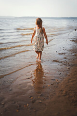 Mom and daughter play summer on the beach