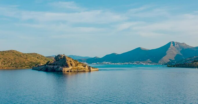 Beautiful movement of clouds over Spinalonga island and movement of shadows from the setting sun, Mirabello Bay, Crete, Greece. Time laps