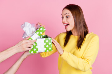 Photo portrait girl unpacking gift box on birthday party amazed cheerful isolated pastel pink color...