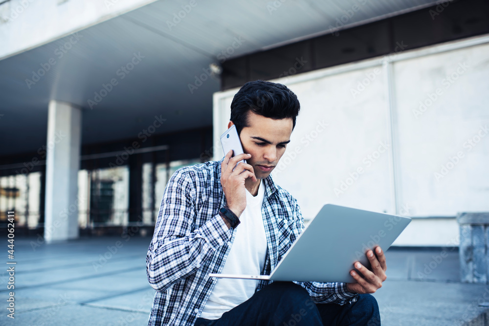 Poster male digital nomad discussing distance job on laptop computer using 4g wireless internet for calling