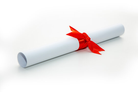 Solemn diploma of the graduate about the completion of studies with a red ribbon on a white background.