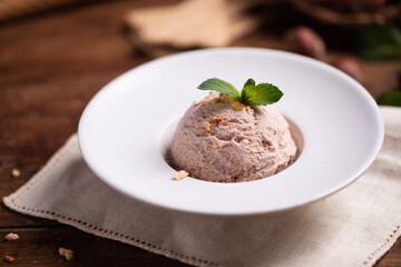Fresh hazelnut ice cream on wooden table