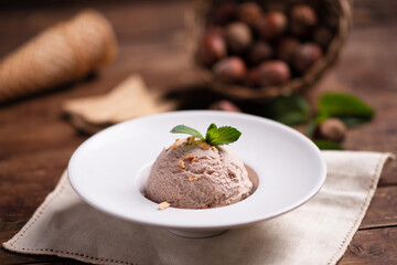 Fresh hazelnut ice cream on wooden table