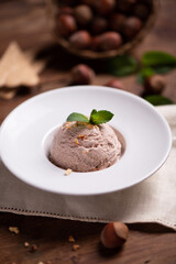 Fresh hazelnut ice cream on wooden table