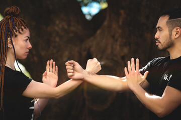 couple practicing kung fu in the park