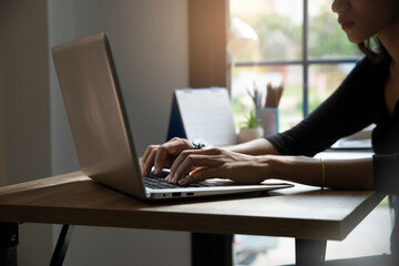 Remote Working from home concept. Hand of Planner typing online via laptop. Asian young...