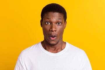 Portrait of attractive amazed stunned guy pout lips news reaction isolated over bright yellow color background