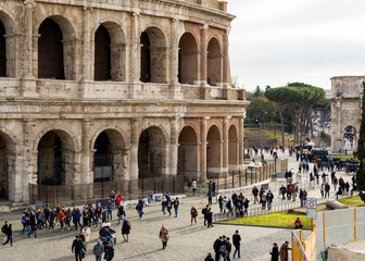 Tourists near the Colosseum, the largest amphitheater ever built, made of concrete and sand, Rome,...