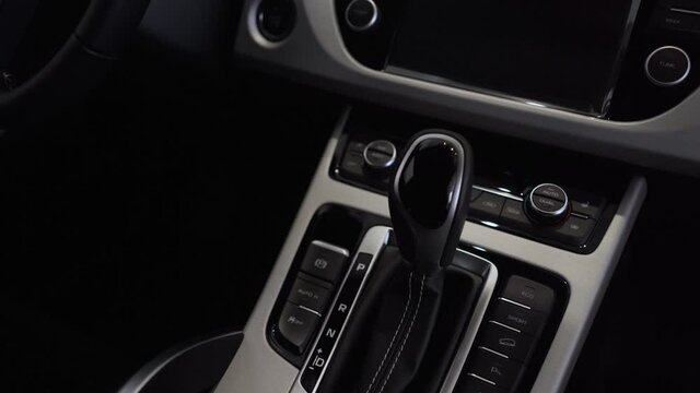 Close-up of the automatic transmission, climate control and control panel in the interior of a new car.