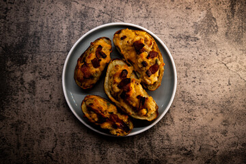 Top down view of Twice Baked potatoes with Bacon and chedder cheese