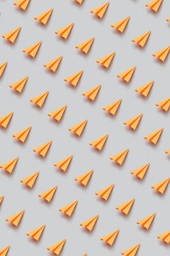 Seamless pattern of orange paperplanes
