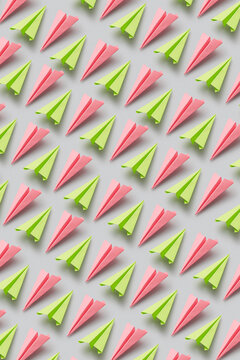 Pattern of green and pink paperplanes
