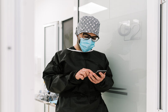 Physician using smart phone in the hospital