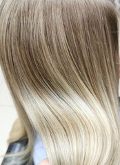 a girl with blond hair in a beauty  salon.air-touch.hair coloring