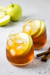 Spiced ginger honey apple iced tea in glasses. Space ofr text.