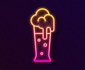 Glowing neon line Glass of beer icon isolated on black background. Vector