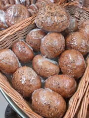 buns made from a mixture of cereals with sunflower seeds in a supermarket baske