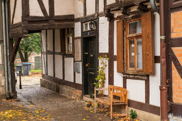Timbered house with a passage and bench at the front door