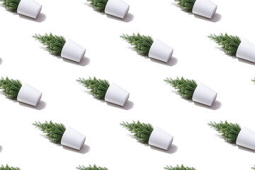 Isometric pattern of small fake Christmas trees on white background