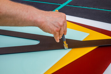 Colored glass. The glazier cuts the painted panes