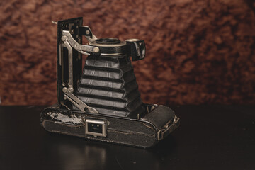 Old camera on an old background on a close-up table