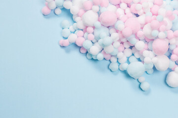 White, pink and blue soft pompons as a background.