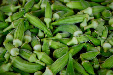 Fresh green okra pods on a market. Food vegetable background