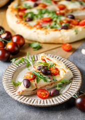 Italian pizza: tomato paste, mozzarella, parma ham, arugula, olives, cherry tomatoes. Ingredients...
