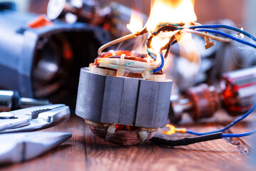 Power tool repair. Details of electrical appliance and repair tools on a wooden table in a repair...