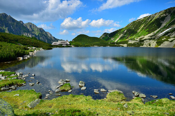 The beautiful lake Przedni Staw and the mountain lodge Schronisko Piec Stawow in the High Tatras,...