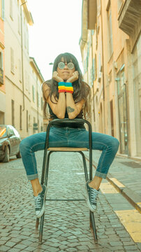 hsipanic latino woman in the street wearing pride lgbt bands