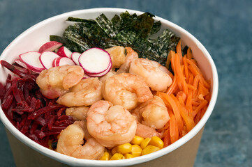 Close-up of shrimp poke with carrots, beets and seaweed.