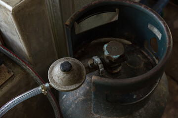 Rusty pressure regulator and operating valve of cooking gas tanks. LPG . Hose connect to the cylinder red gas supply. 